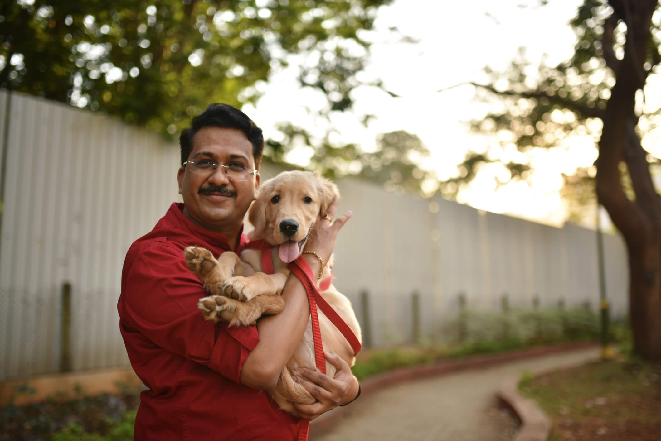 Man cuddling and holding his pet dog in his hands