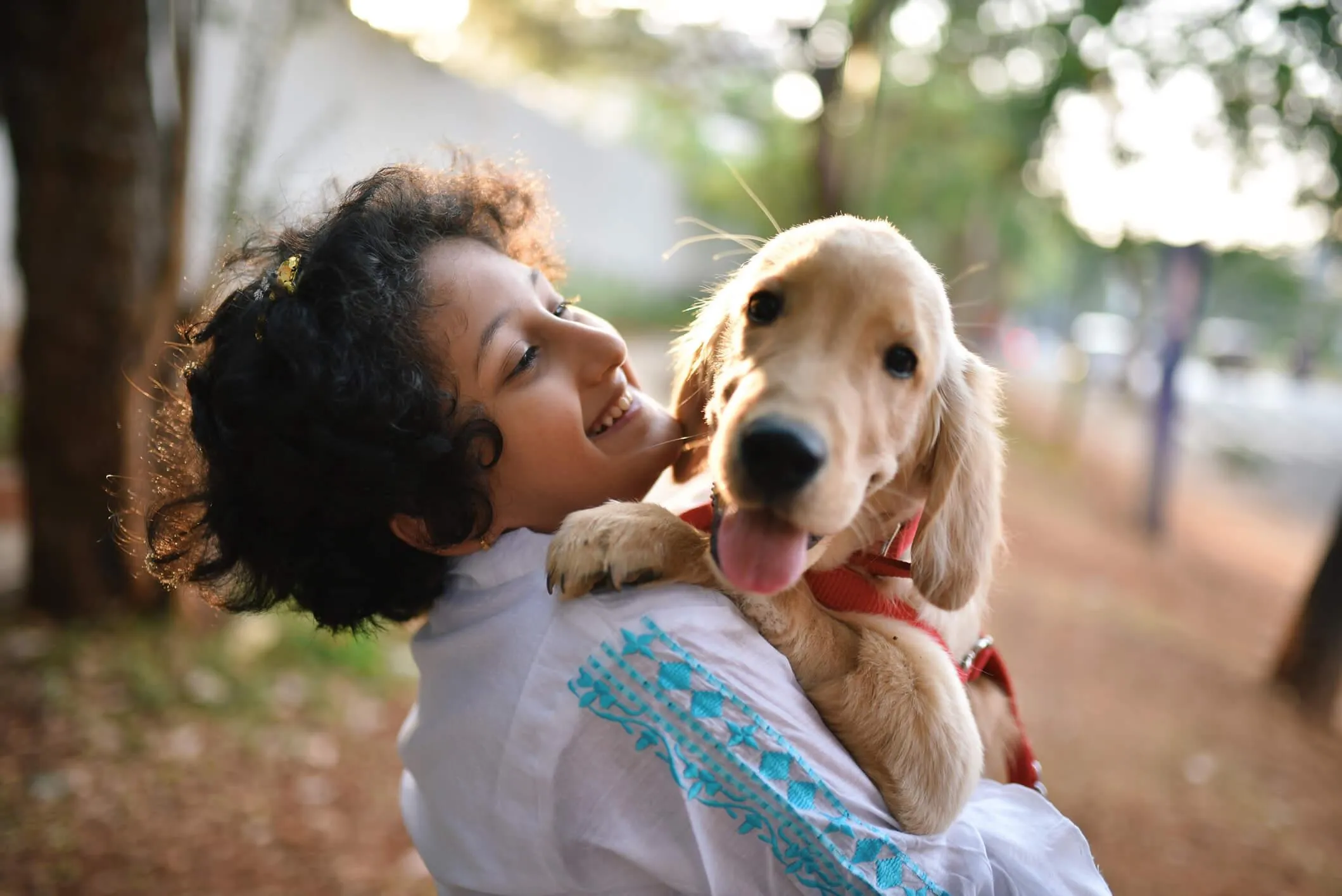 Girl with her golden retriever puppy